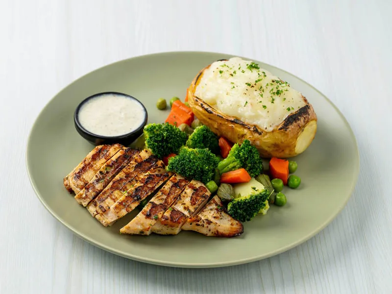 Grilled chicken plate from a consistently lit Looptales menu series